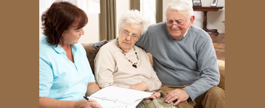 older clients discussing Medicare marketing messages and reviewing options