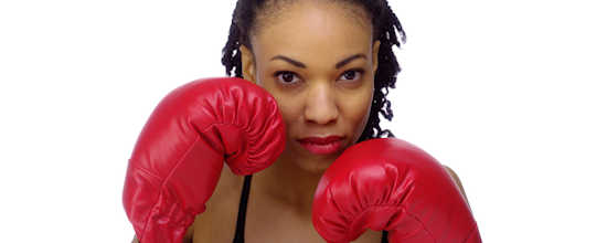 Black woman wearing boxing gloves