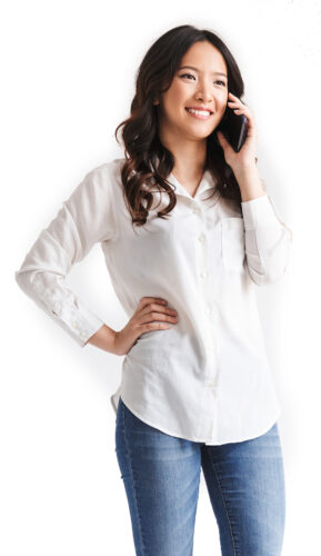 Full length photo of brunette chinese woman with long dark hair holding smartphone and having mobile call, isolated over white background in studio