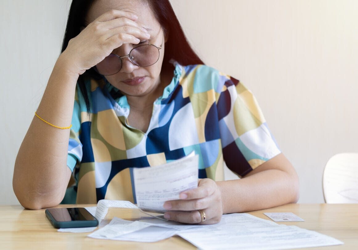 woman reviewing medical bills medical billing errors