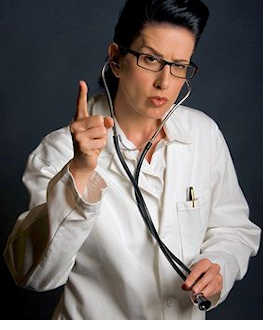Female health care professional with stern look raising finger